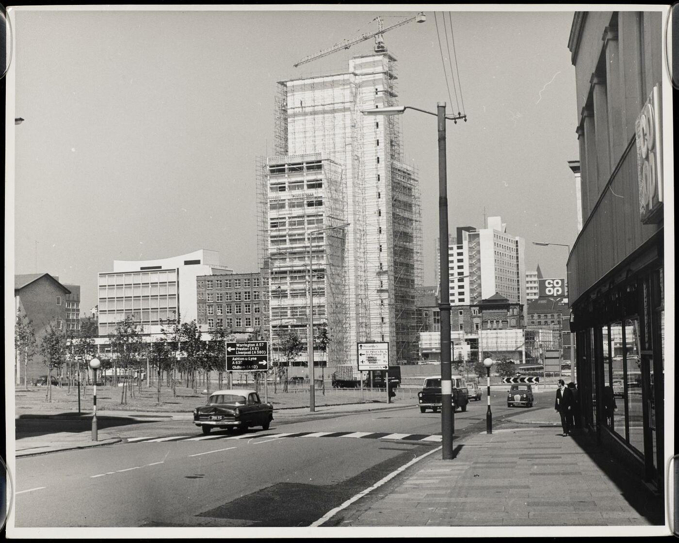 View of the MSS tower under construction, cloaked in scaffolding and with a crane above. 