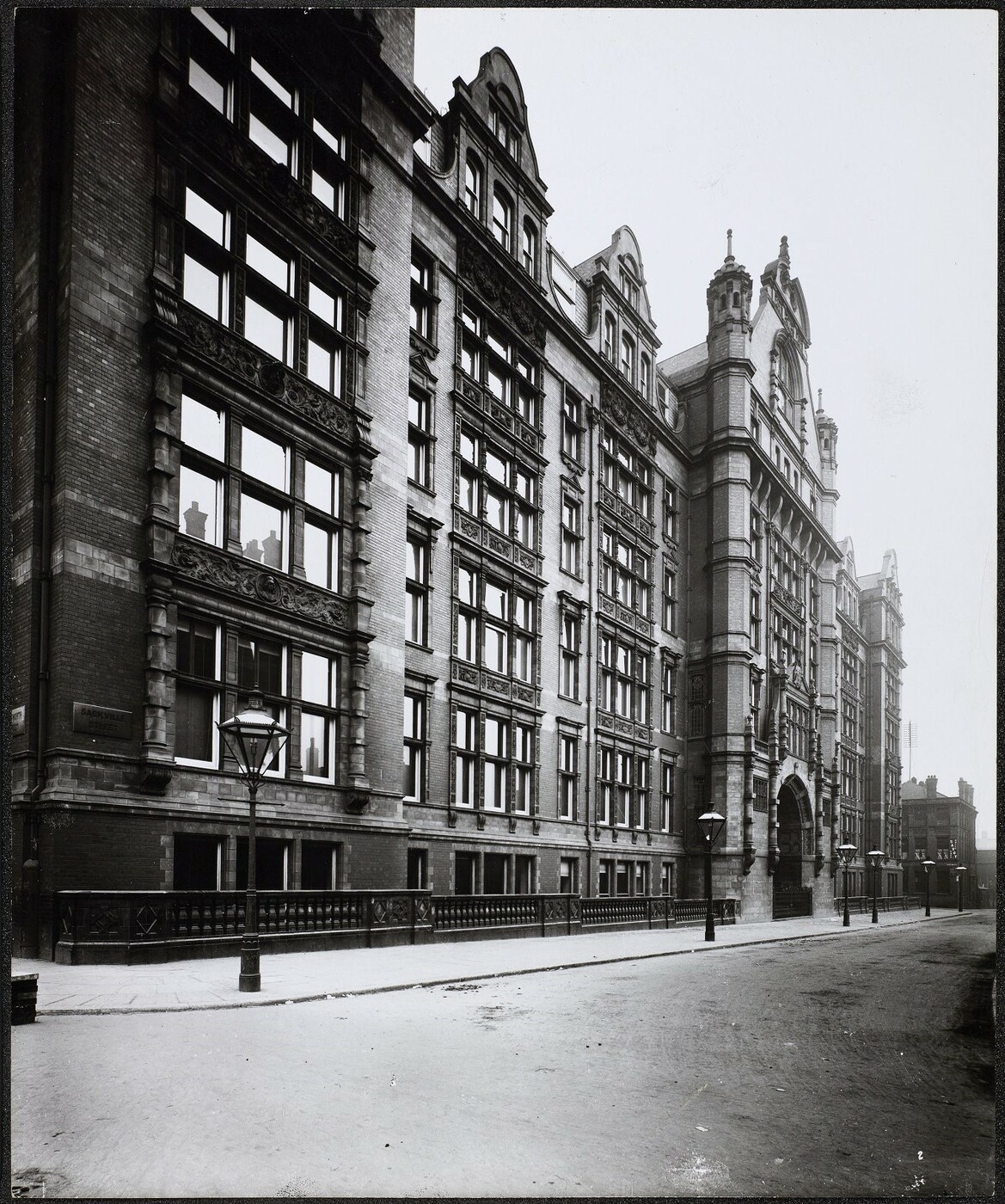 Exterior view of the Sackville Street building, along the visible length of Sackville Street there are old style street lamps. 