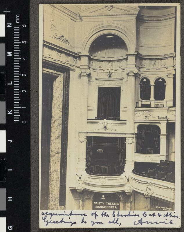 Postcard depicting boxes and balconies of the Gaiety Theatre Manchester. Handwritten on bottom border is "acquaintance of the Cheshire cat and Alice. Greetings to you all, Annie". On bottom right corner is the photographer's inscription "F. W. Robinson Manchester". 