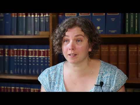 Video showing Elizabeth Gow sat in the John Rylands Research Institute and Library, with book shelves in the background. 