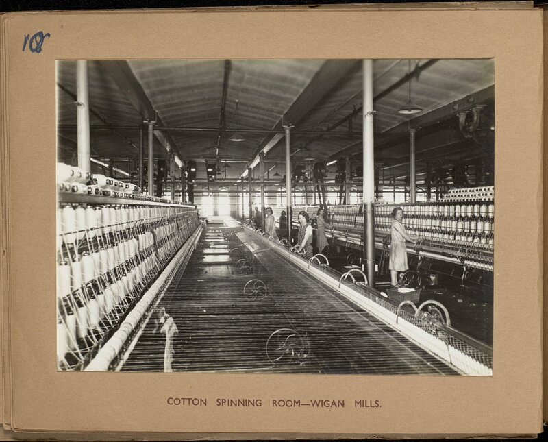 Photograph showing women at work operating machinery in a cotton mill.