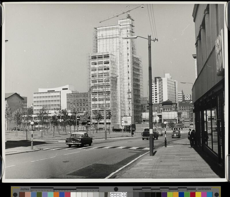 View of the MSS tower under construction, cloaked in scaffolding and with a crane above. 