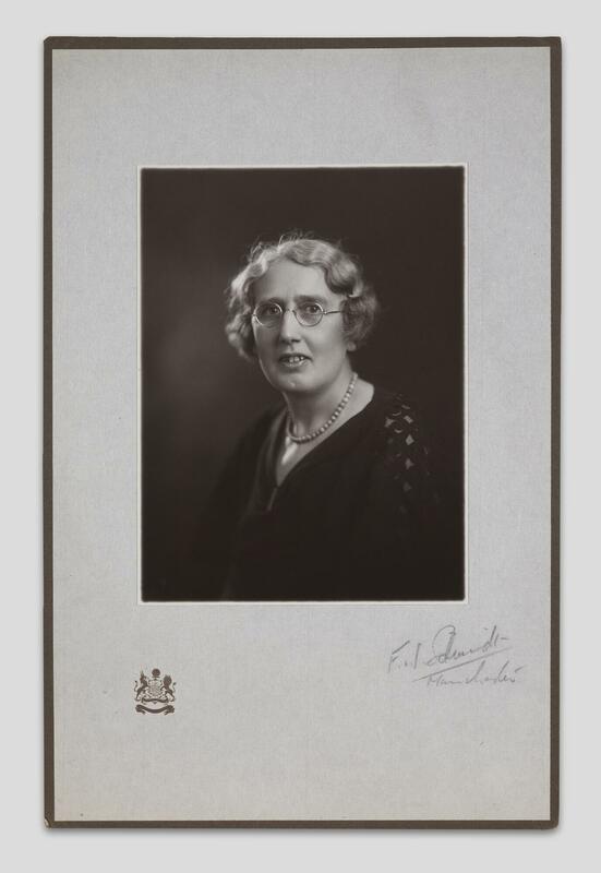 Black and white portrait photograph of Dr Catherine Chisholm, signed by Manchester photographer F.W. Schmidt, and featuring the crest of the city of Manchester in its frame.